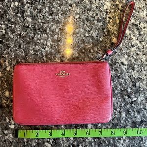 Small pink Coach Wristlet